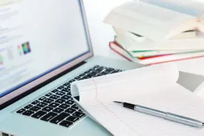 AIMH | Image showing a laptop and paperwork
