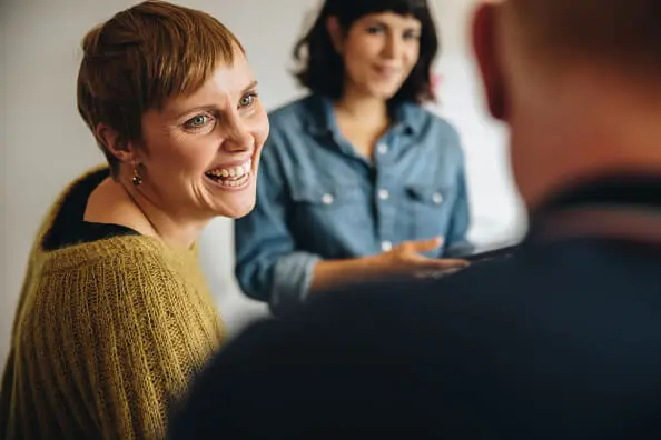 AIMH | Image showing a women chatting with others