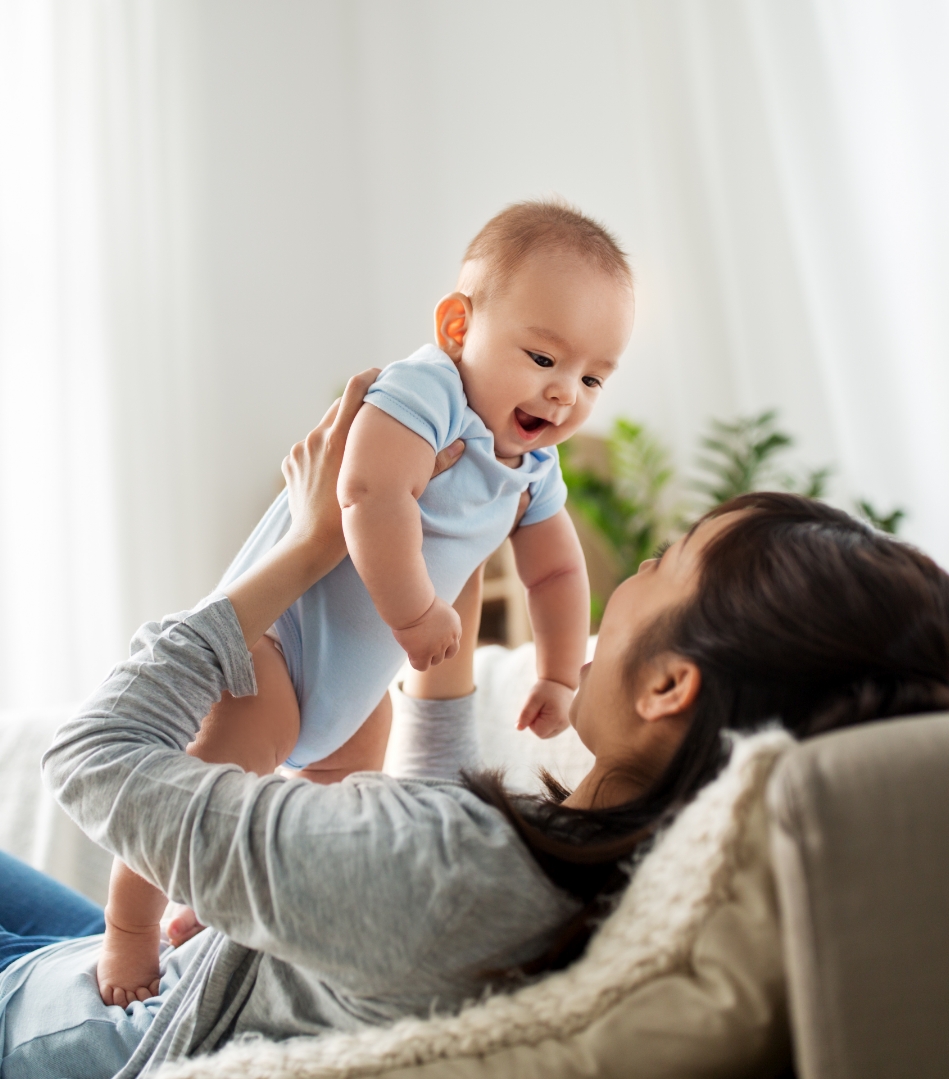 AIMH | an image of a mother holding a baby up